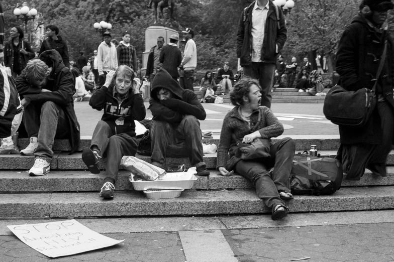 group of people sitting on the steps at the same time