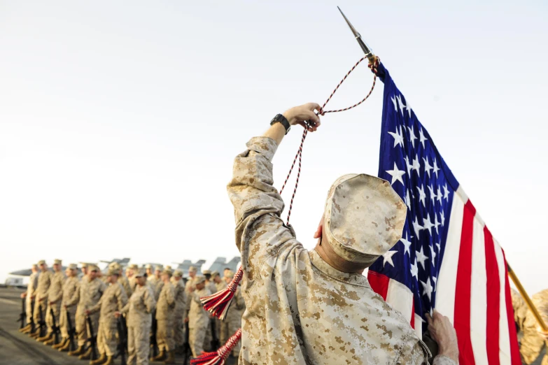 a group of soldiers from the army hold an american flag