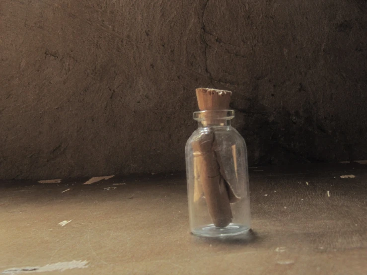 an empty bottle with a small wooden cork in it