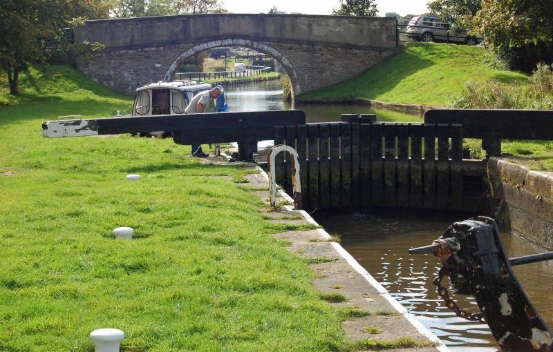 small narrow canal in urban area with boat passing through