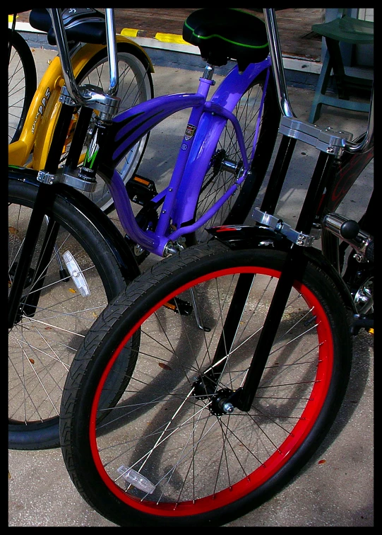 three bicycle wheels are standing in front of a bench