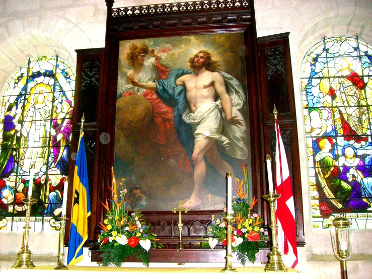 an ornate church alter with stained glass windows and religious artwork