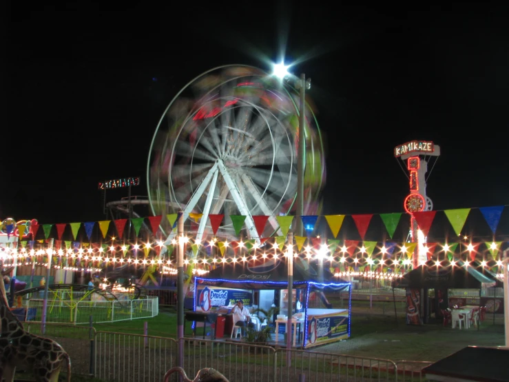 a carnival with rides and brightly lit christmas lights