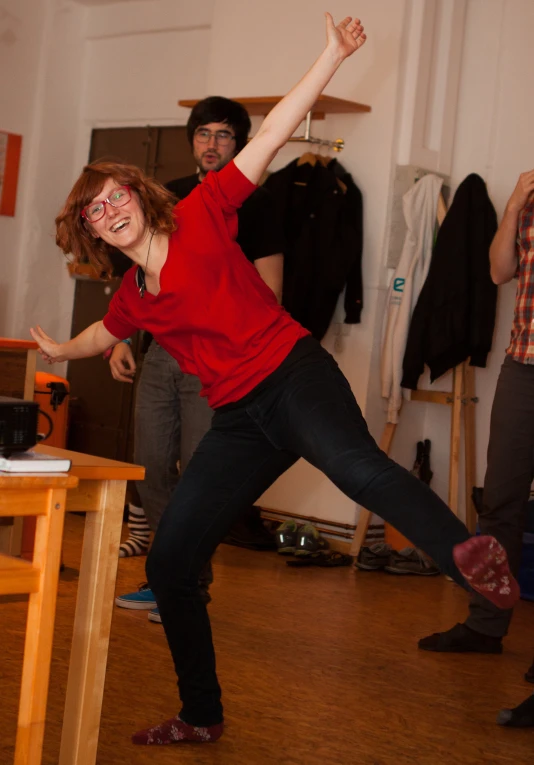 a woman in red shirt playing a game with wii motes