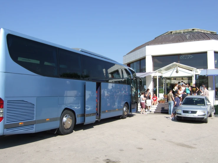 two passenger buses stopped on the side of a road