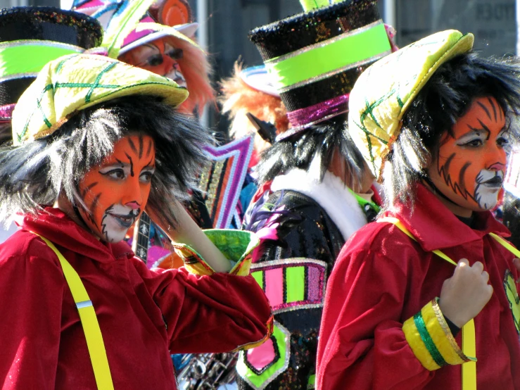 men with tiger face paint and hats in parade