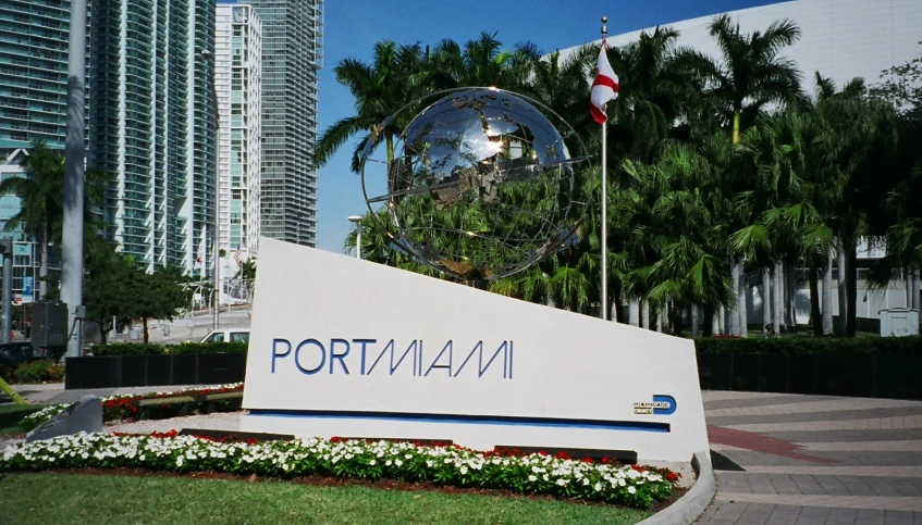 the sign is located in front of two tall buildings