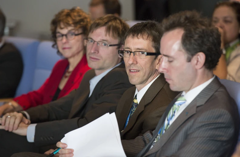 a group of people with glasses watching soing