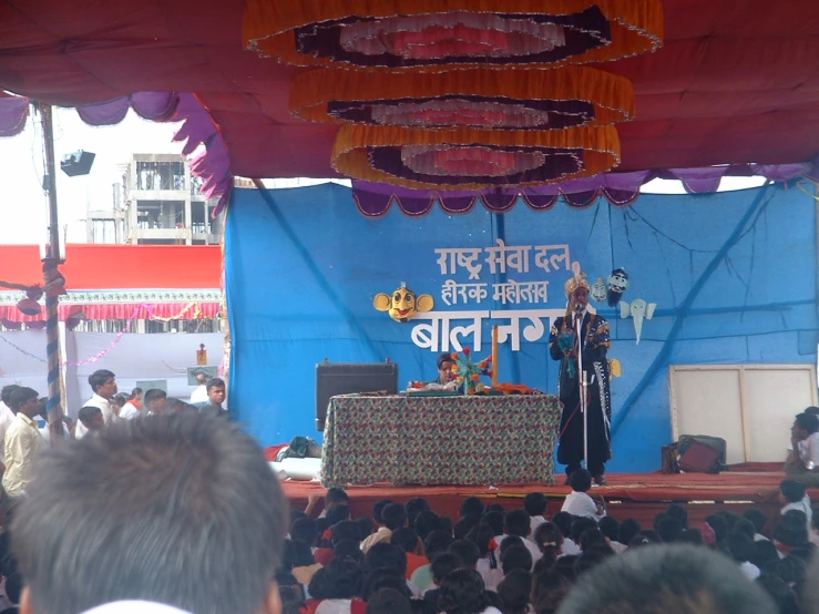 an audience looks on as performers play at the stage