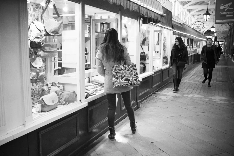 two women shopping inside of an outdoor food market