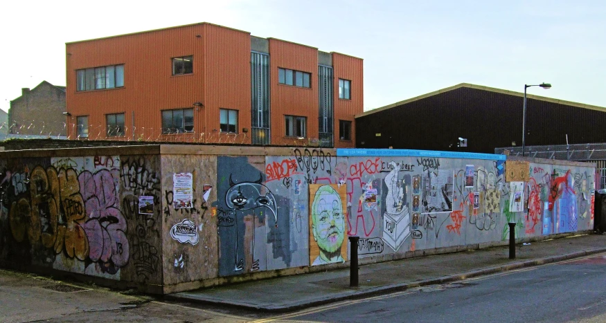 a road with graffiti on it and a building in the background