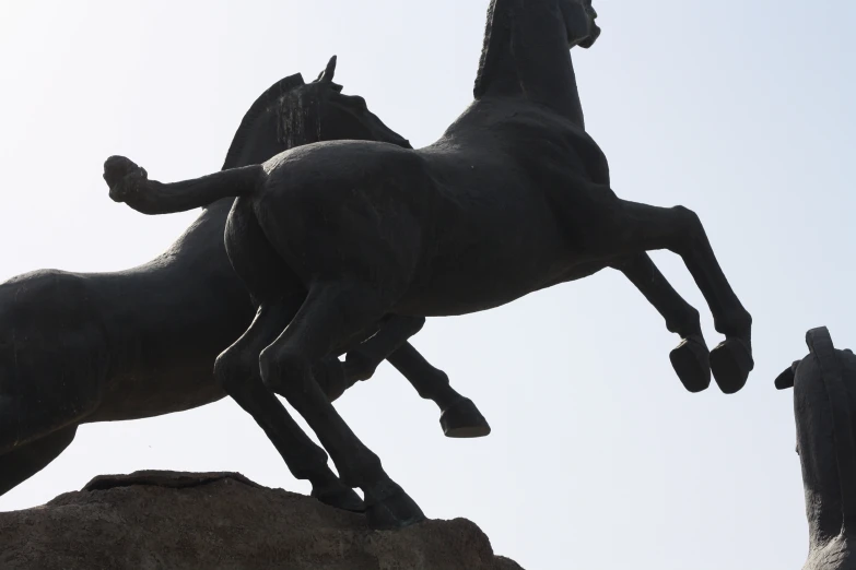 statues depicting two horses, one running the other