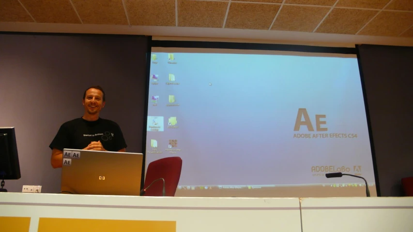 a man standing behind a podium at a presentation