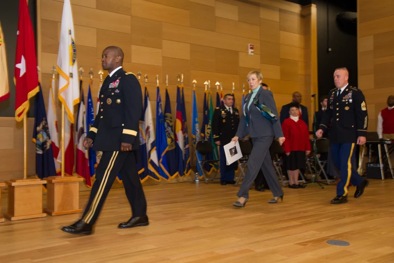 a man and woman walking in front of flags