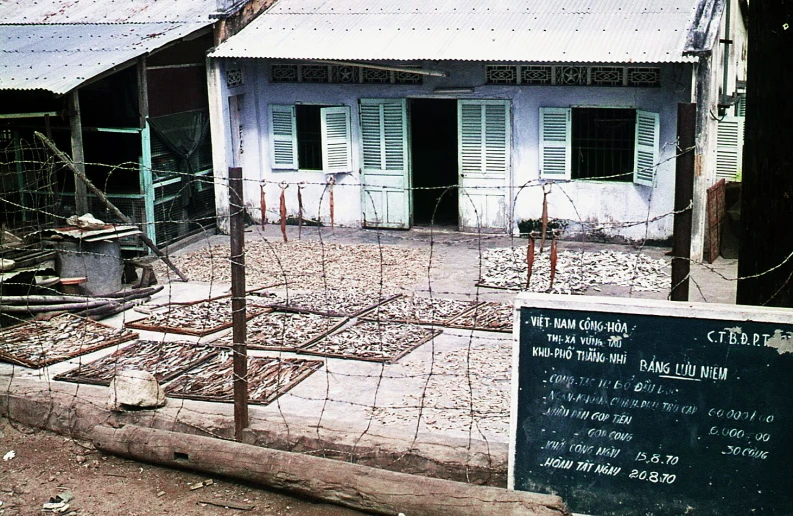 an old abandoned building with fence on top