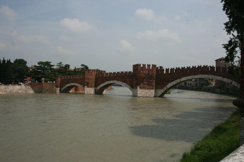 the old bridge crosses over a river in the city