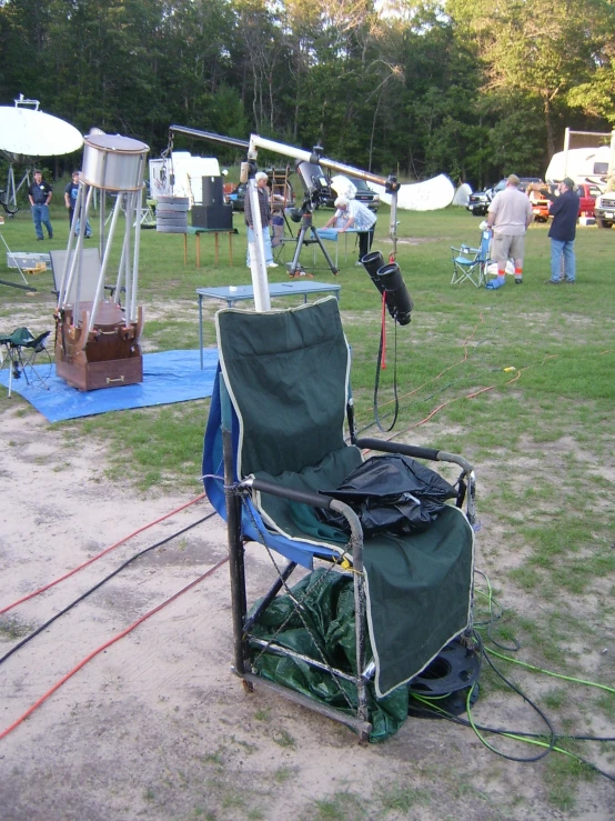 a chair sitting on the ground while some people are looking around