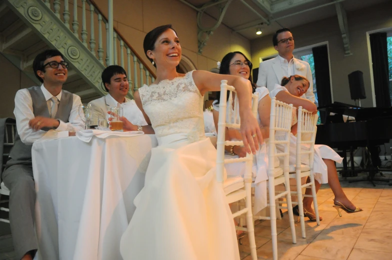 the bride and groom are sitting down having fun