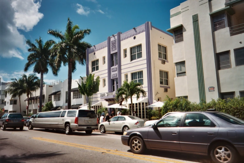 several cars are parked on the side of a street