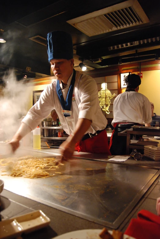 a chef prepares food behind the counter of a restaurant