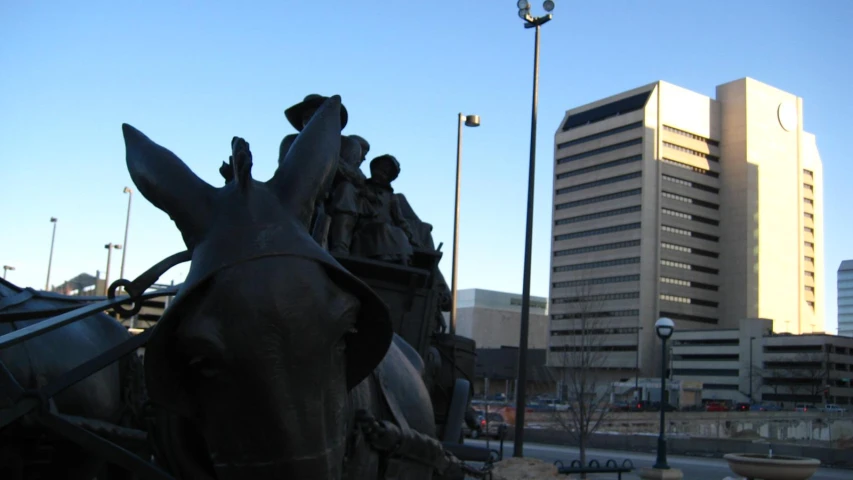 a statue of people on horses in the street