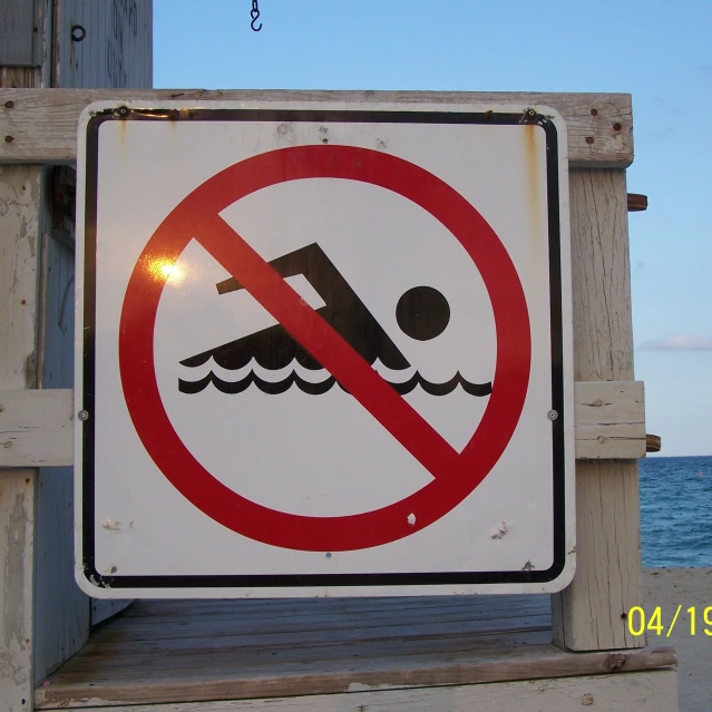 a sign stating no swimming is allowed at this point