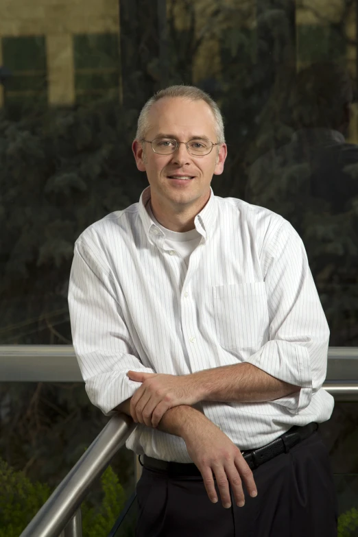 a man is standing with his arms crossed