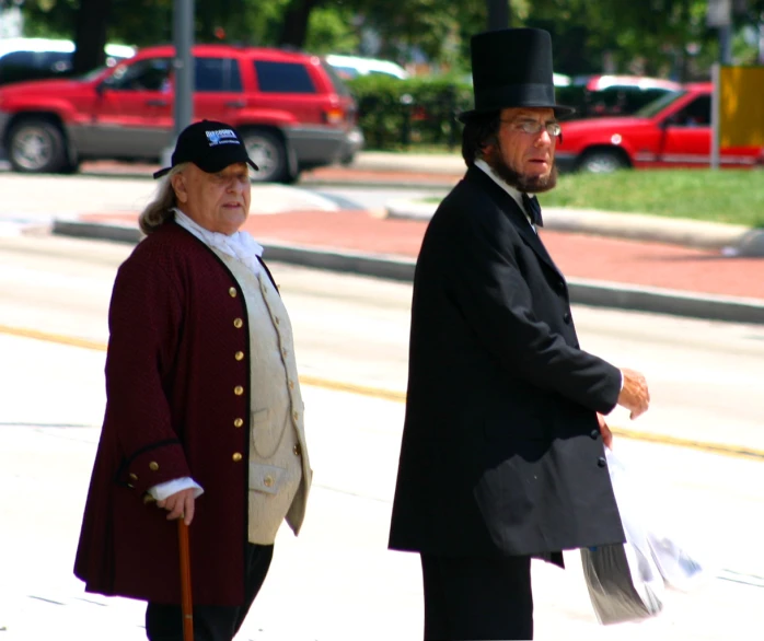 two old men standing side by side on the street