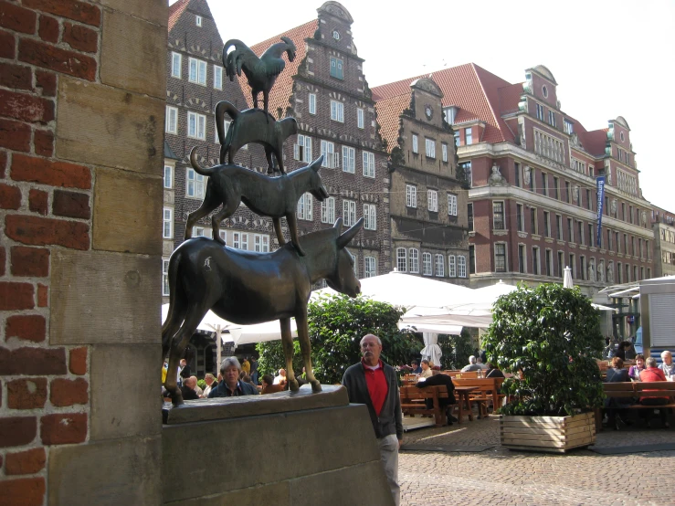 the statue in front of the people's place of eating is on display