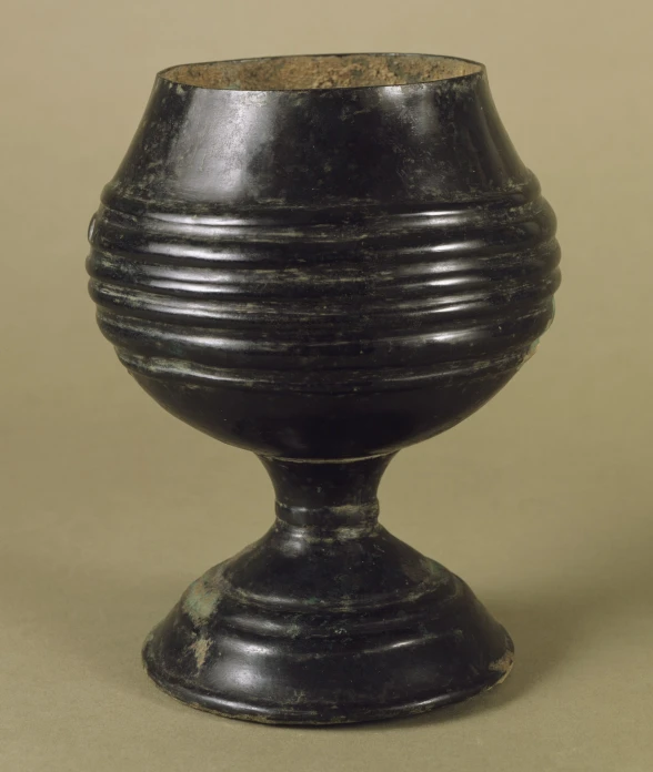 a black pot with a wooden decoration