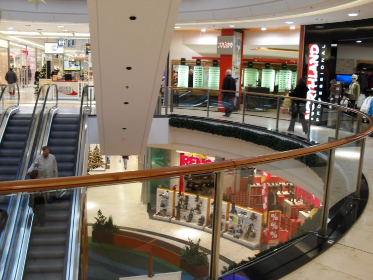 an escalator in a mall with a lot of shops