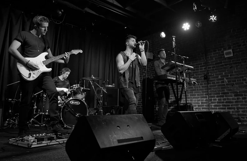 a band performs on stage in black and white