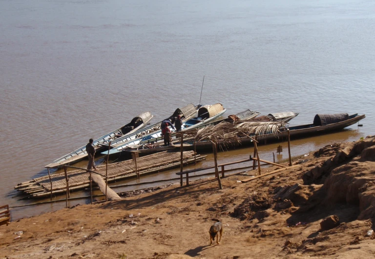 several boats tied to a dock on a large river