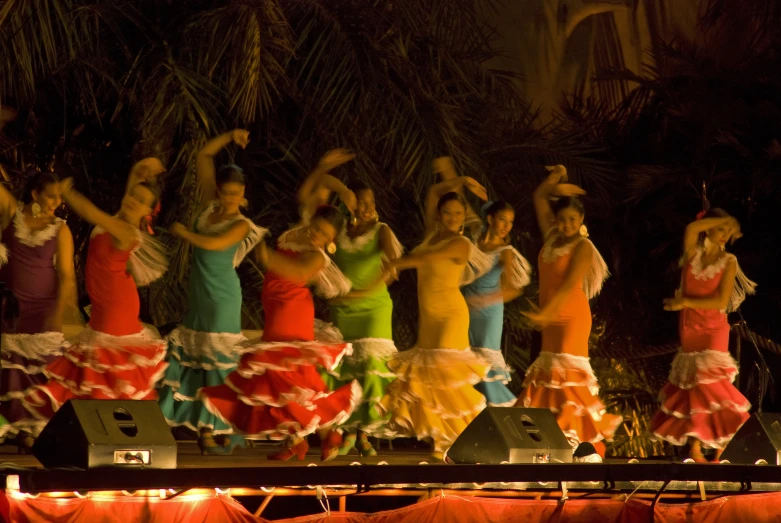 a group of women in brightly colored dresses