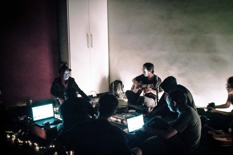 group of people using computer in the dark