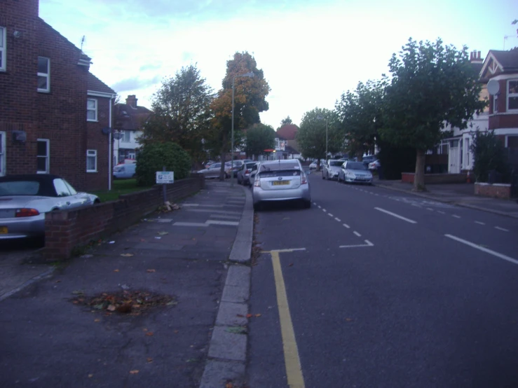 a small police car is traveling down a town street