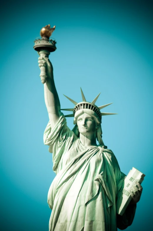 a close up of a statue of liberty on a clear day