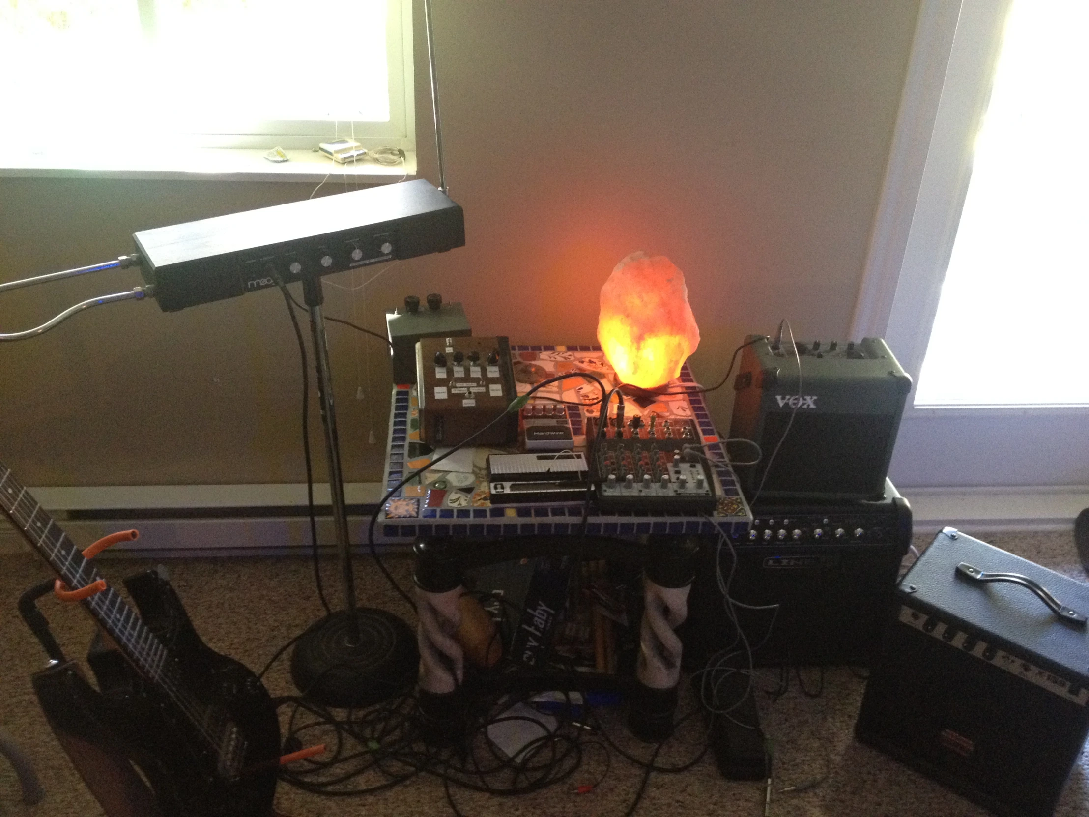 a bunch of instruments and some lights by a window