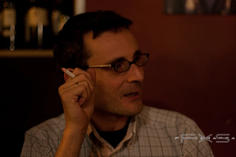 a man wearing a on up shirt and glasses