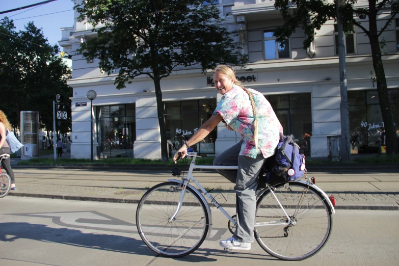 a woman riding her bike down the road