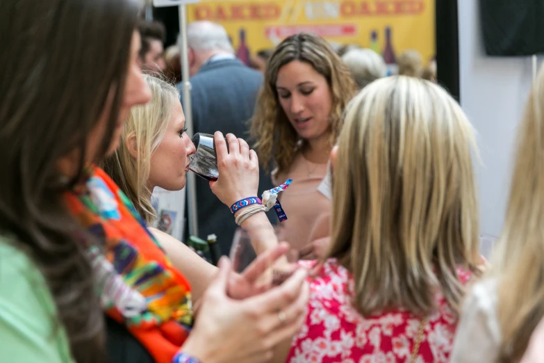 a woman looking at her phone while another woman looks on