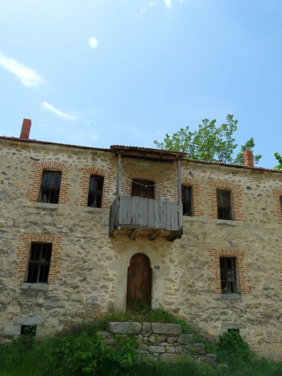 a brown brick building with wooden doors and windows