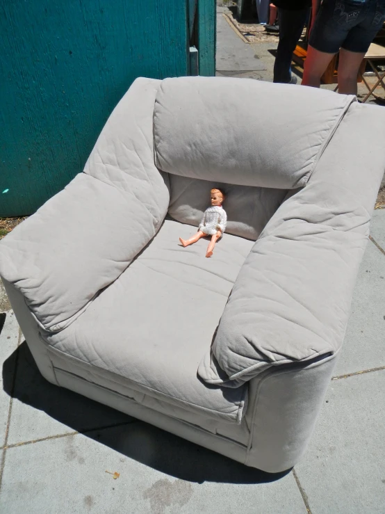 a couch chair made to look like it has a baby doll inside