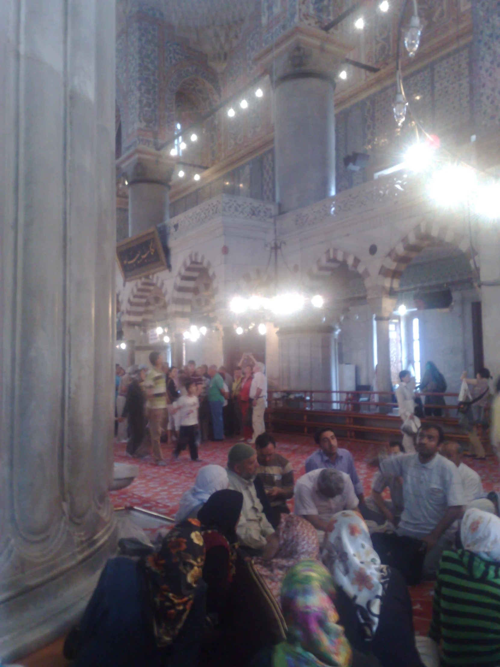 several people in a prayer hall at night