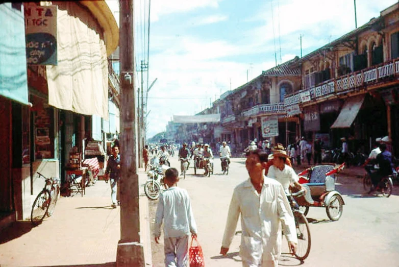 people walking down the street near old - fashioned buildings