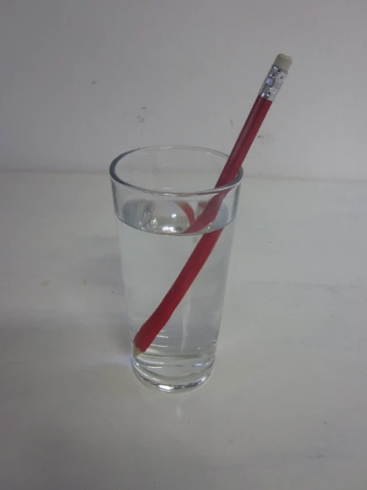 a glass of water and a toothbrush resting in the cup