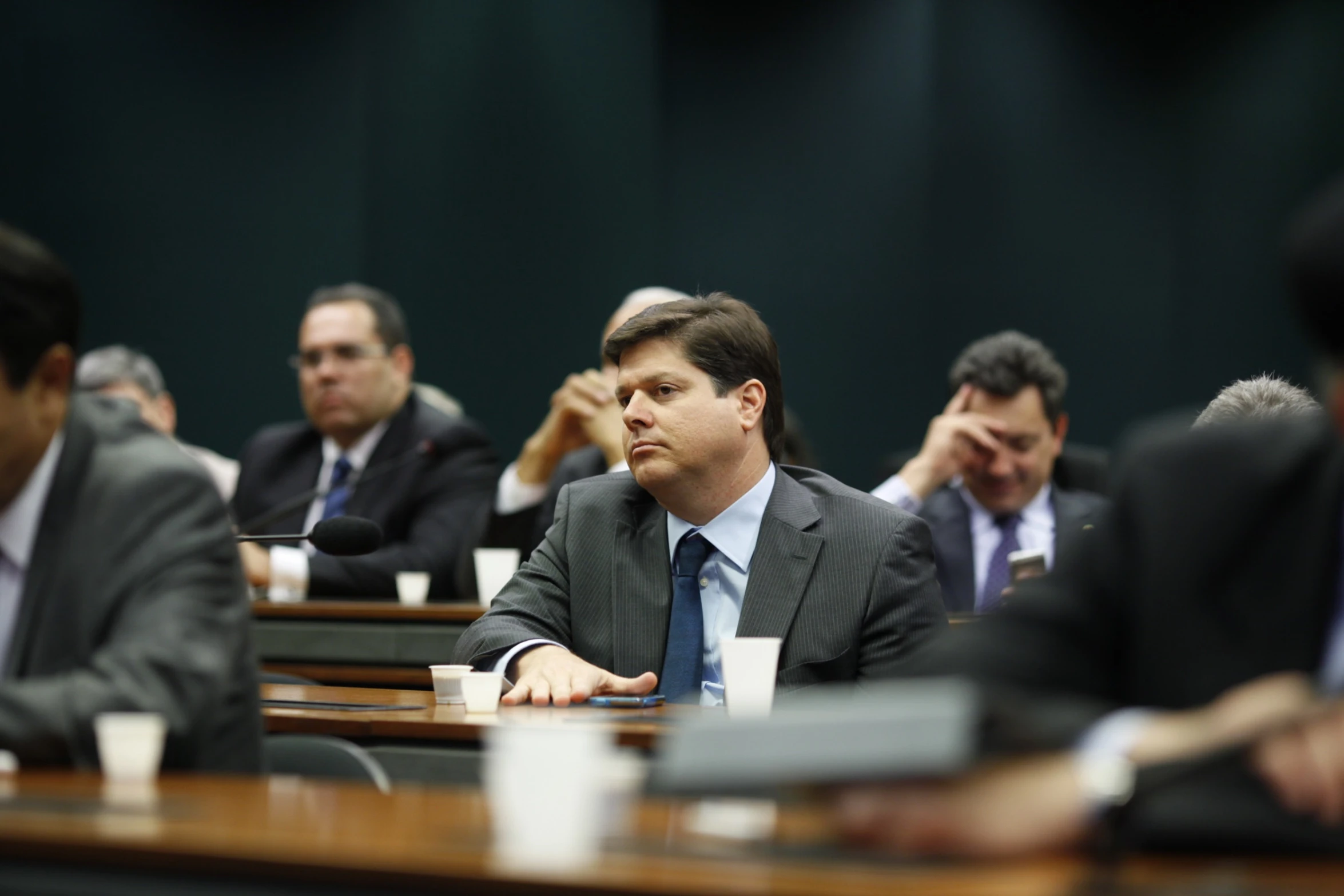 several people at tables, with one man in suit