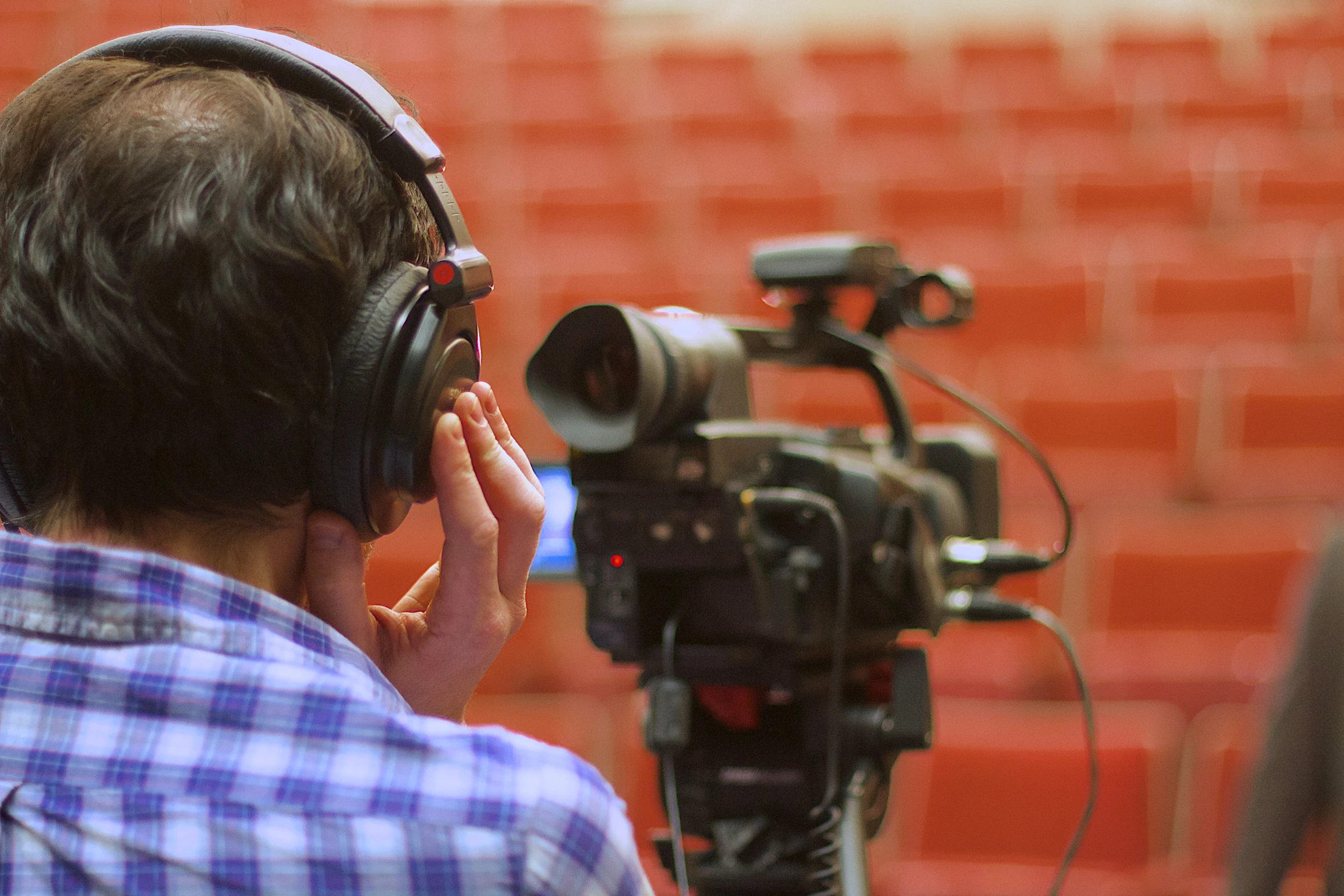 the man is using his camera and headphones