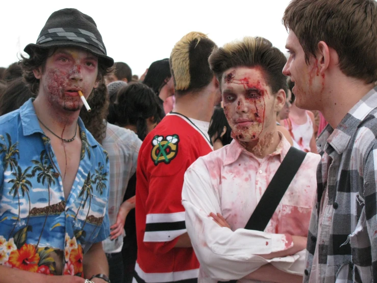 a group of young men with  and makeup on their faces standing together