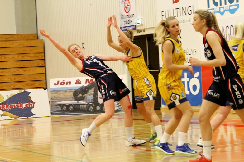 several female basketball players playing on a court